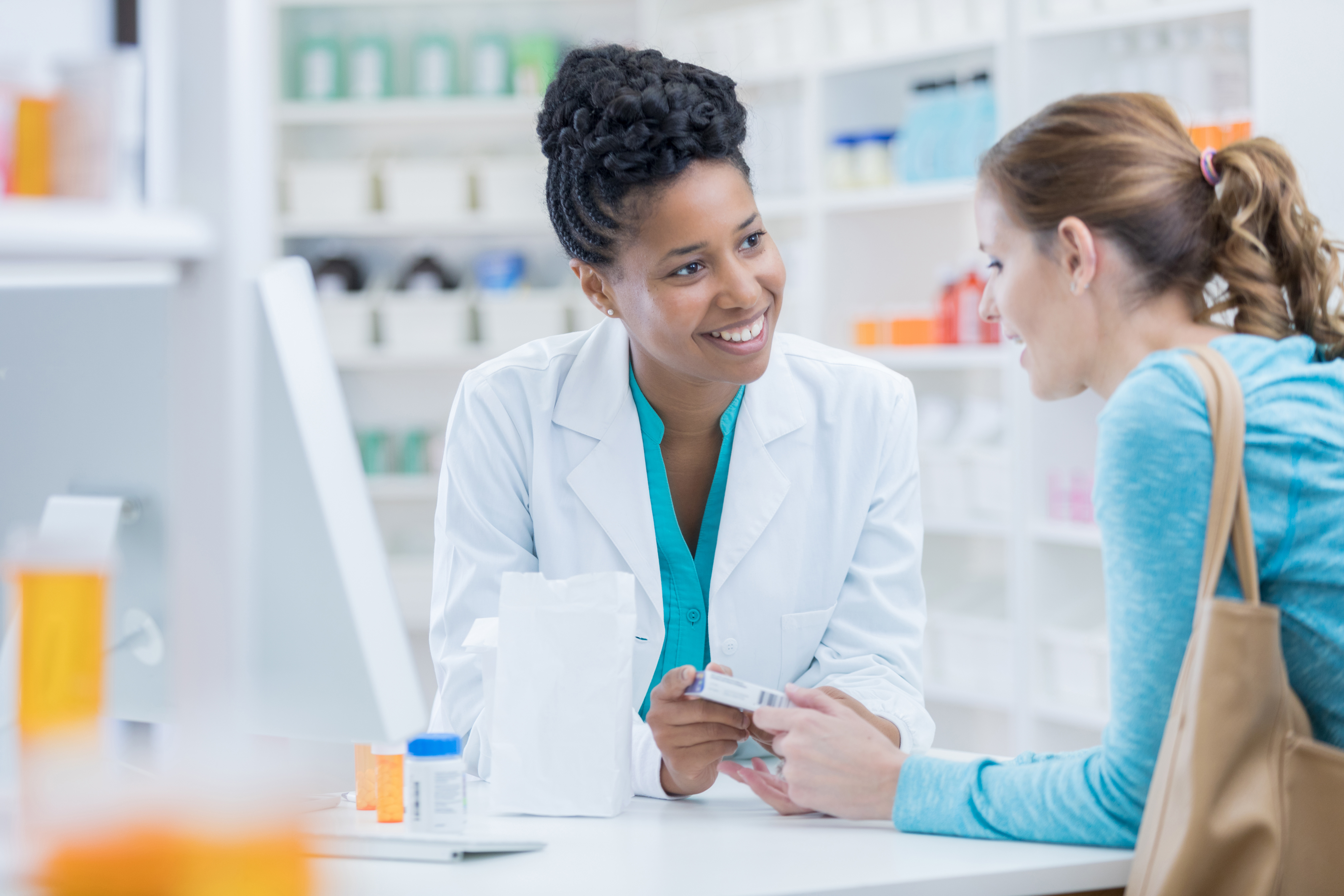 Female pharmacist talking to a female customer