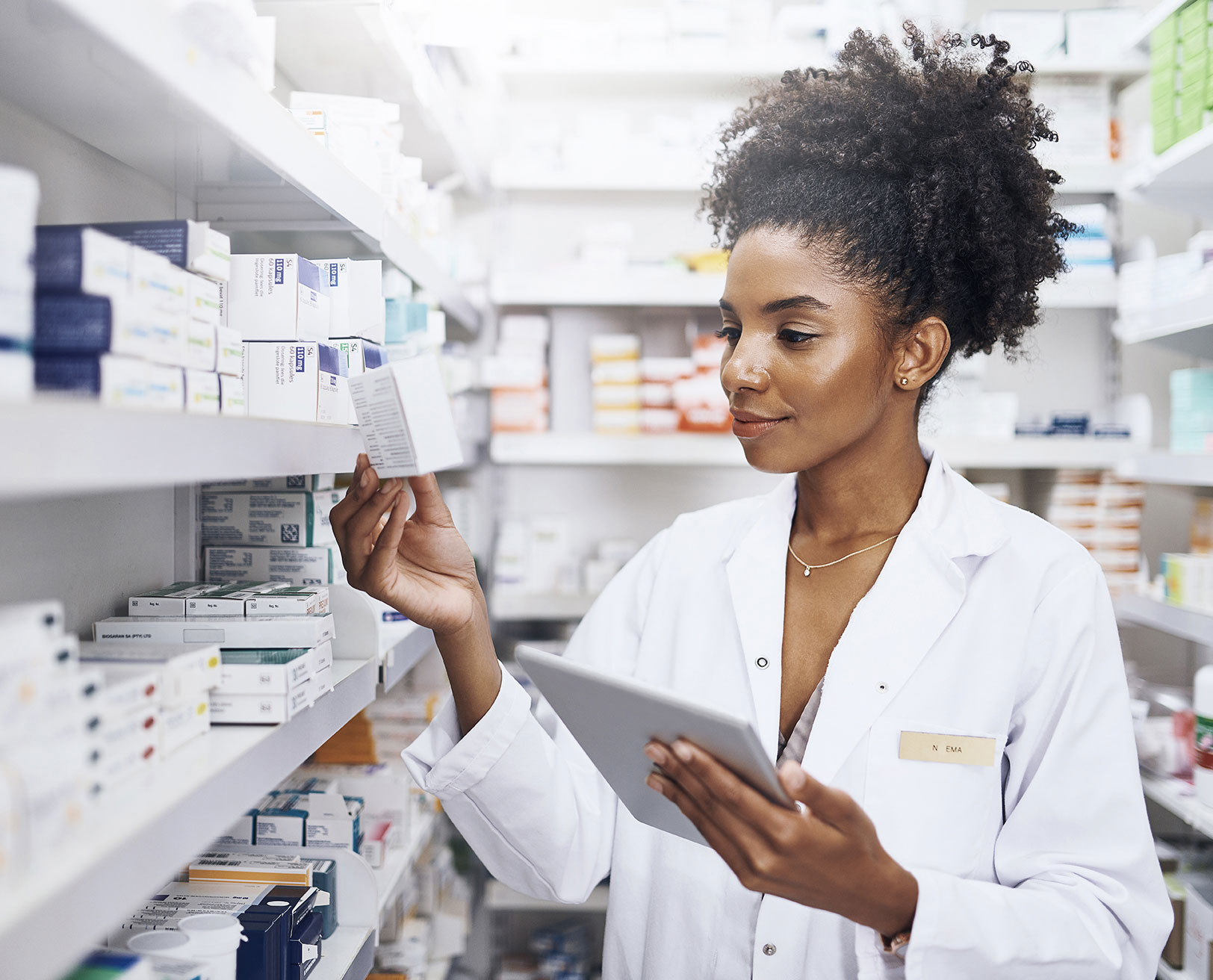 woman pharmacist looking at medication